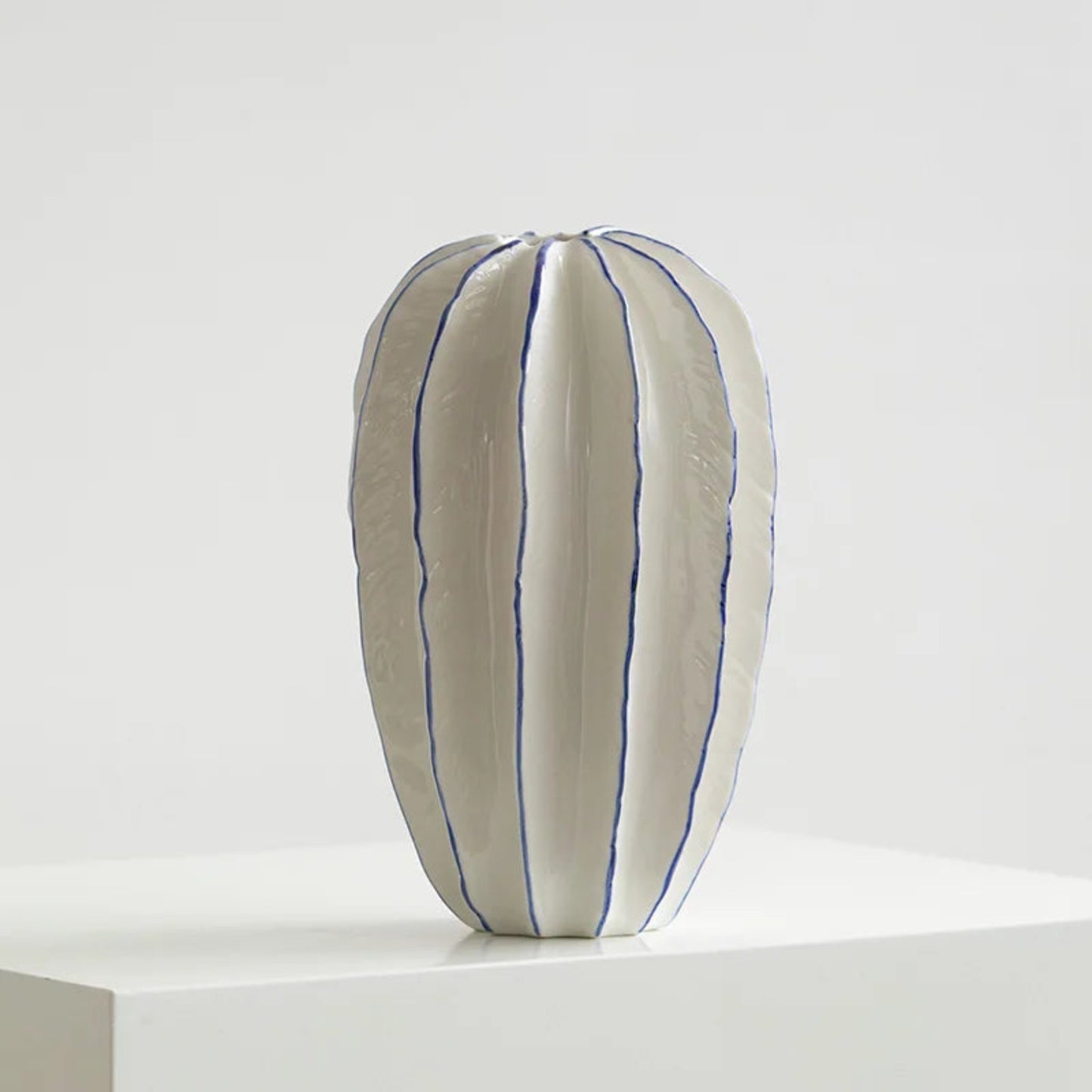 White pillow with blue stripes on a white background