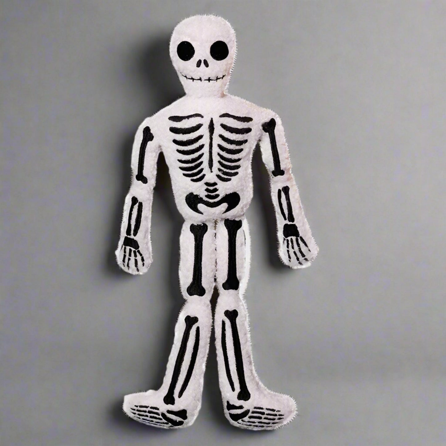 Plush skeleton toy on a white background