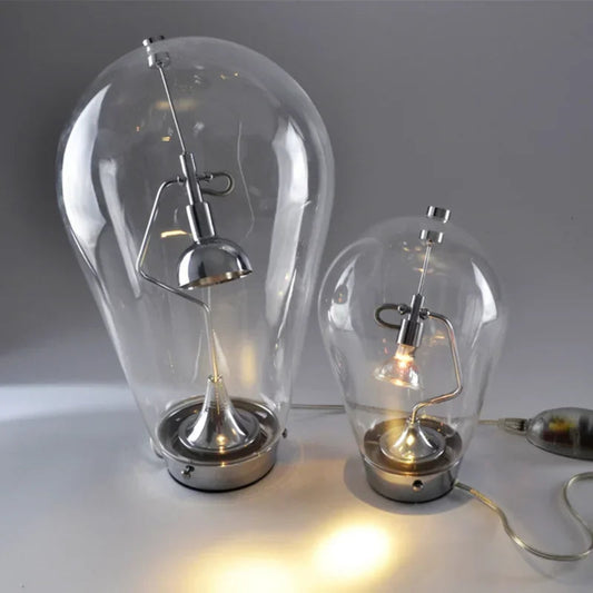 Two glass bulb lamps with metallic bases on a white surface.