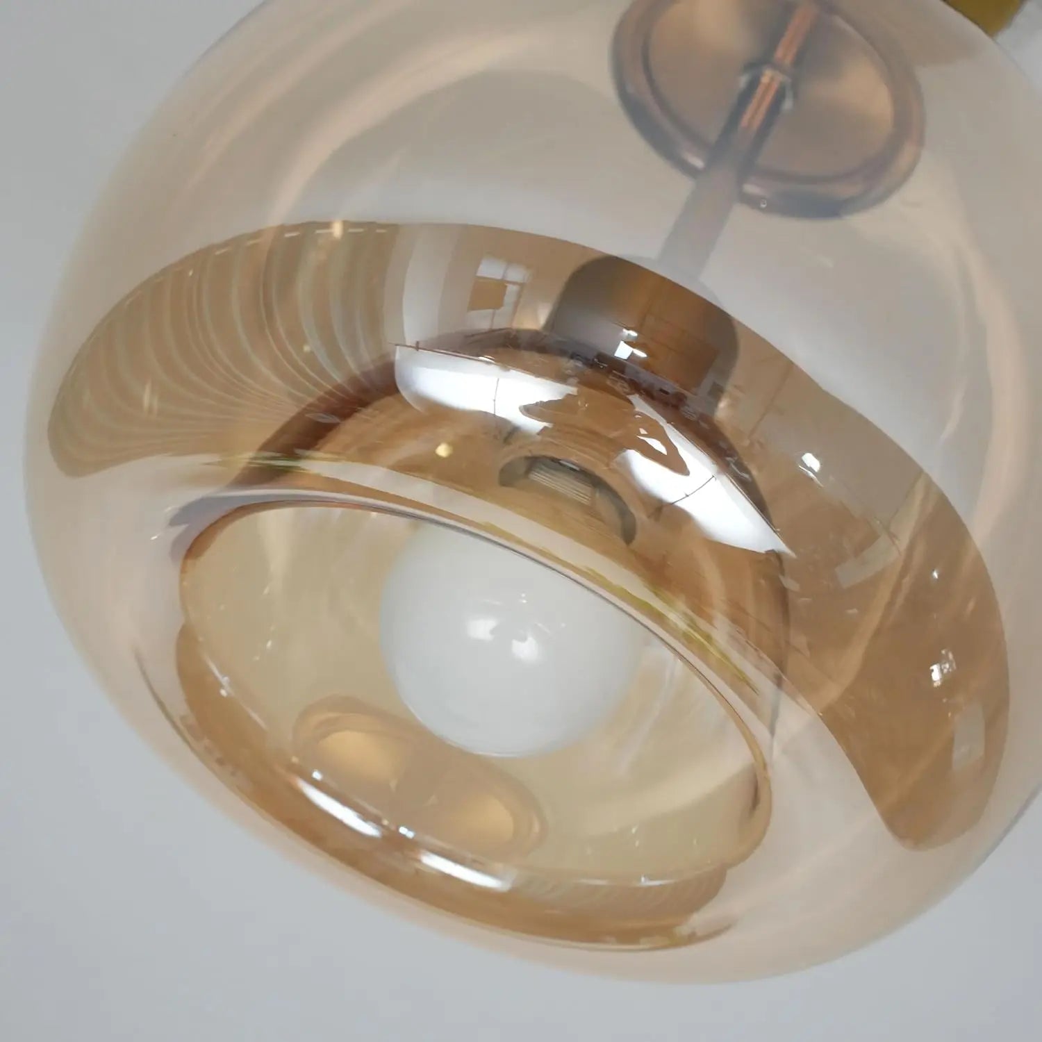 Ceiling light fixture with glass shade on a white background