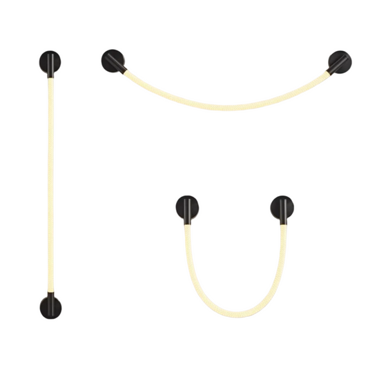 Modern wall lights with curved and straight light strips on a gray background