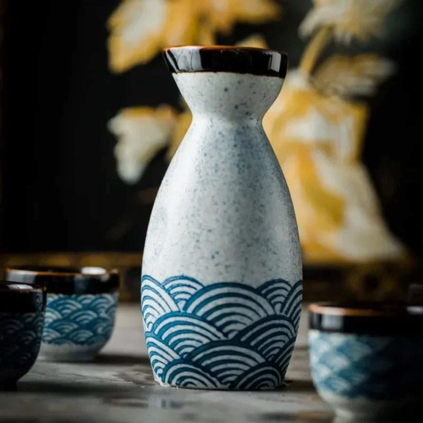 Ceramic bottle with wave pattern on a wooden surface with blurred background