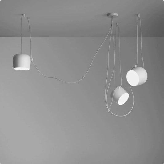 Modern pendant lights hanging from the ceiling against a gray background