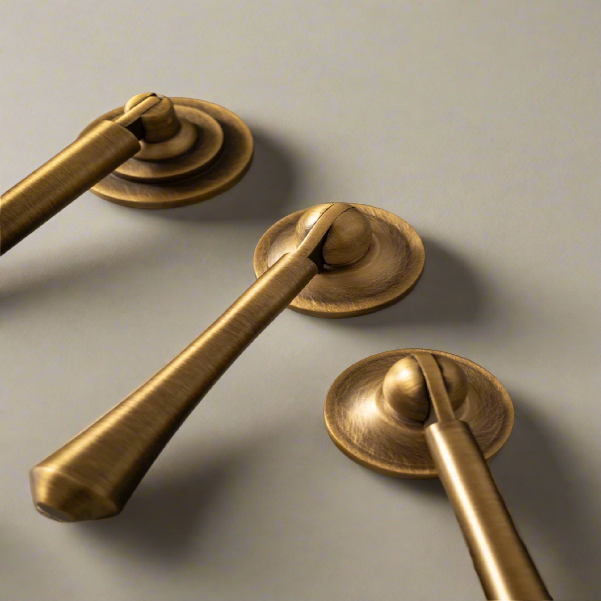 Gold door handles on a gray surface with 'Santaya' branding.