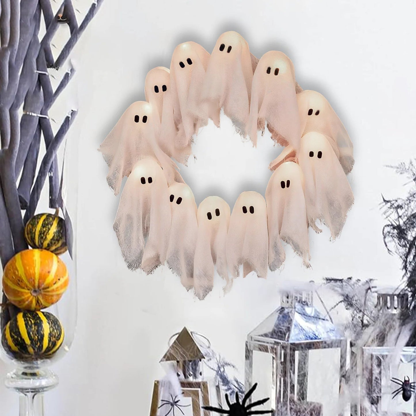 Halloween wreath with ghost decorations on a white background