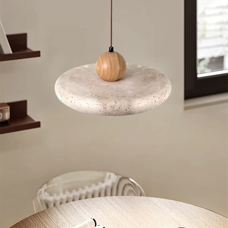 Pendant light with marble base and wooden sphere in a room setting