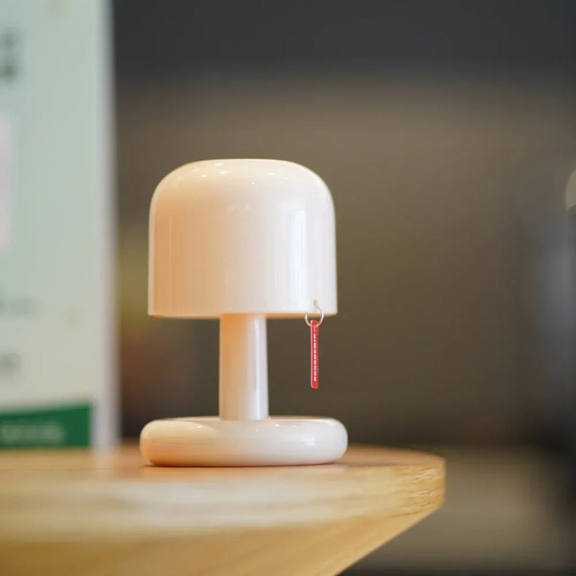 Small white lamp with a wooden base on a surface