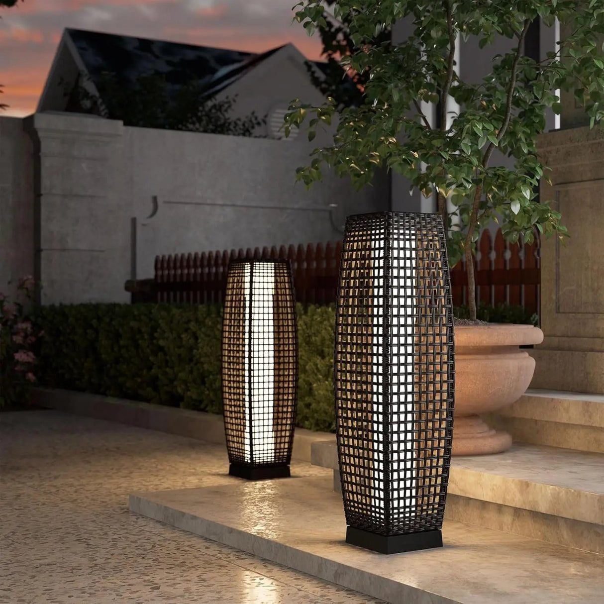 Two outdoor lamps on a patio with a building and tree in the background