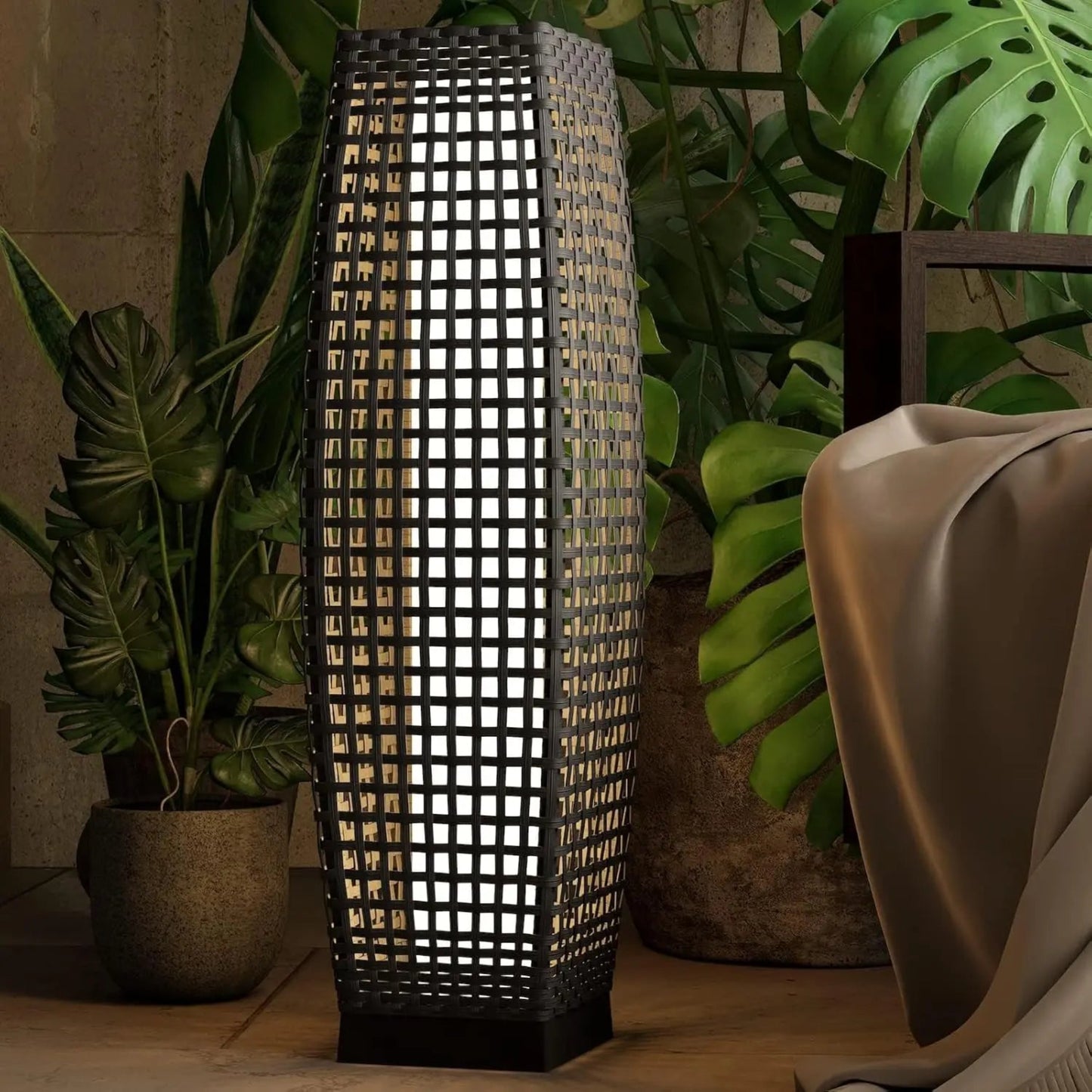 Decorative lamp with woven design in a room with plants and furniture.