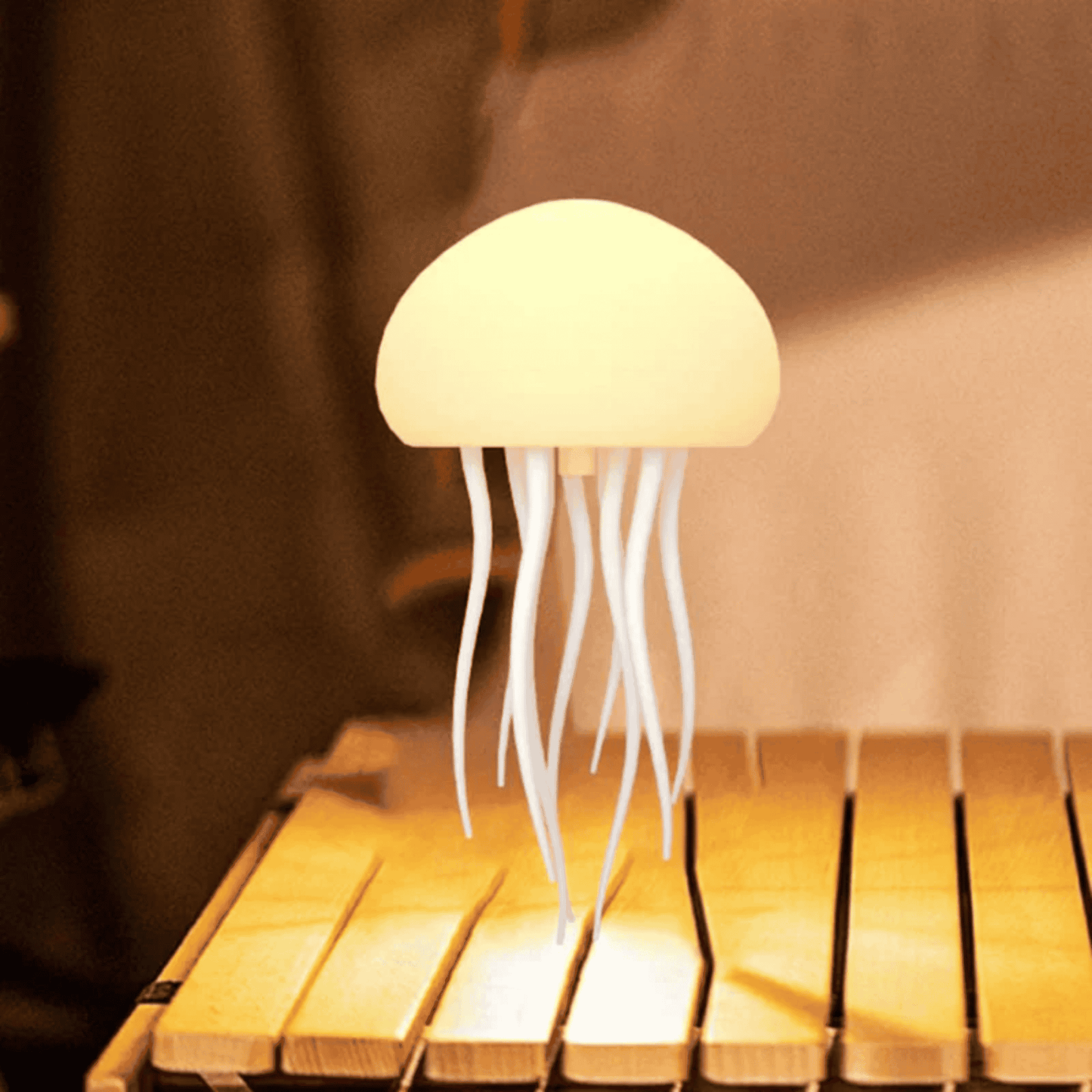 Jellyfish-shaped lamp on a wooden surface with a warm glow