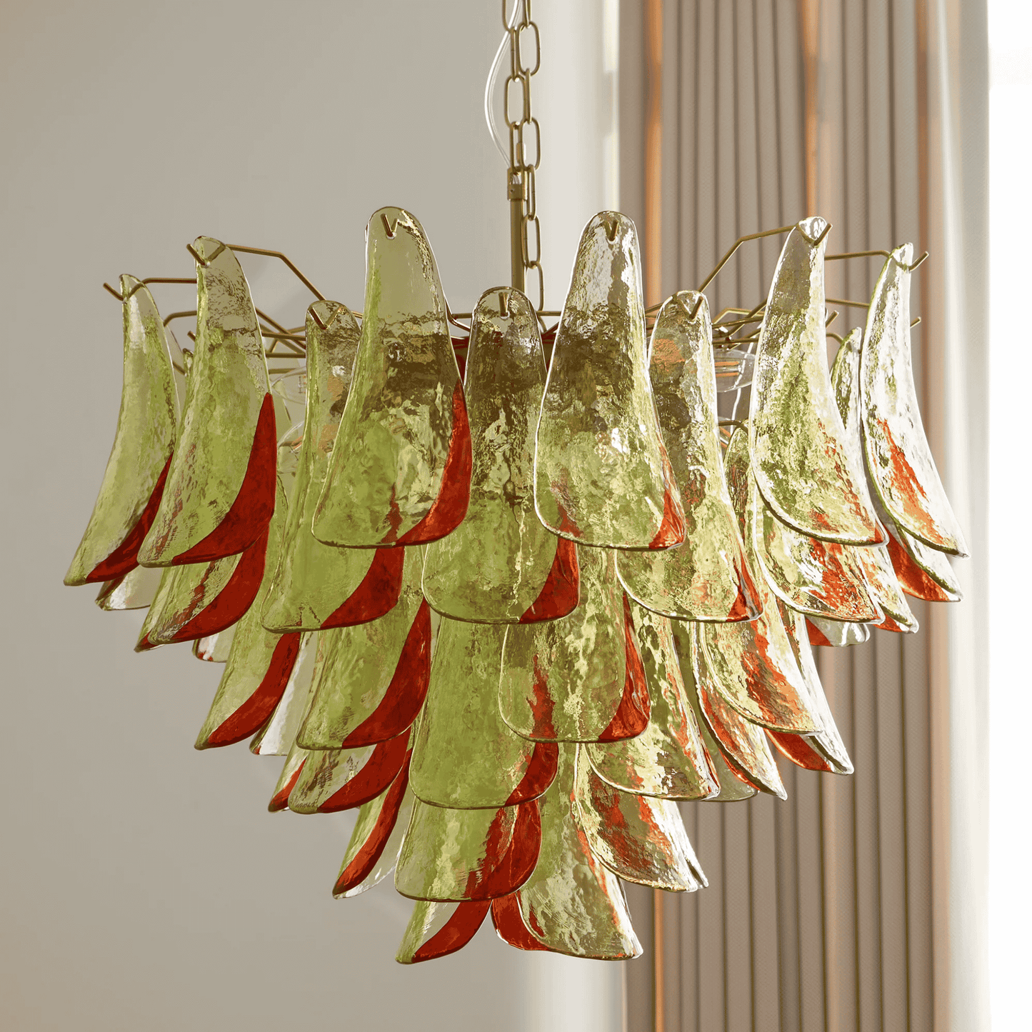 Chandelier with green and red glass panels on a neutral background