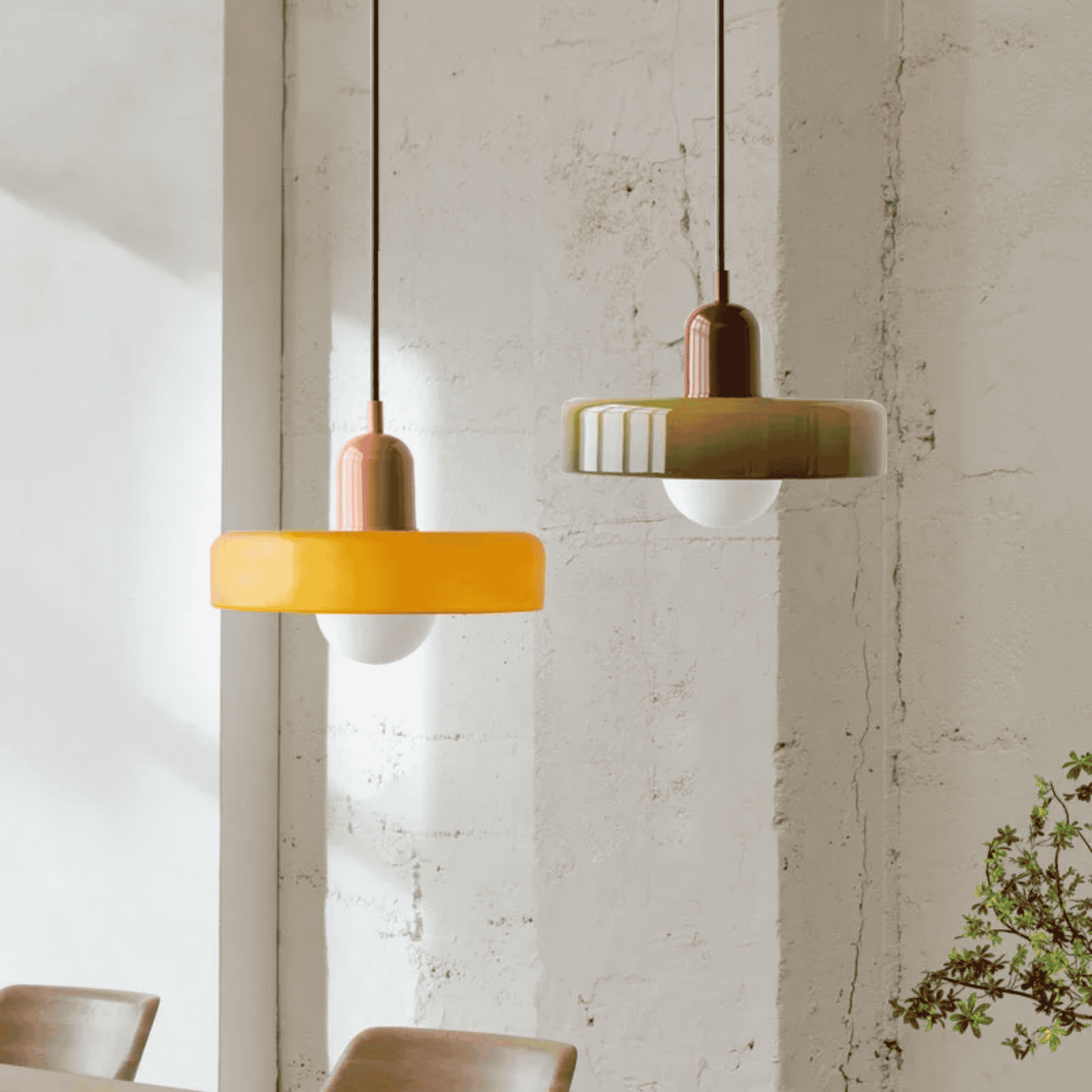 Two pendant lights hanging from the ceiling with a neutral background
