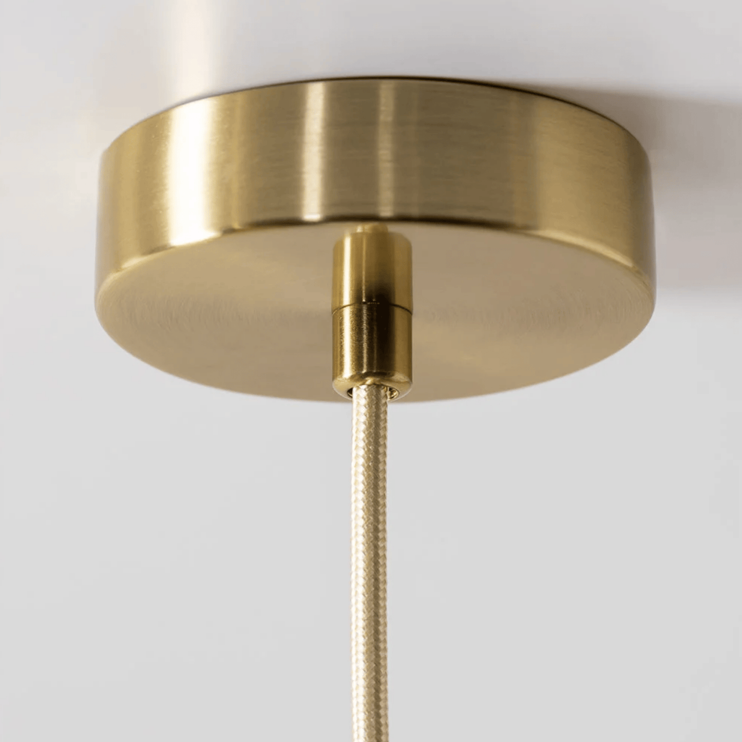 Close-up of a gold ceiling light fixture on a white background