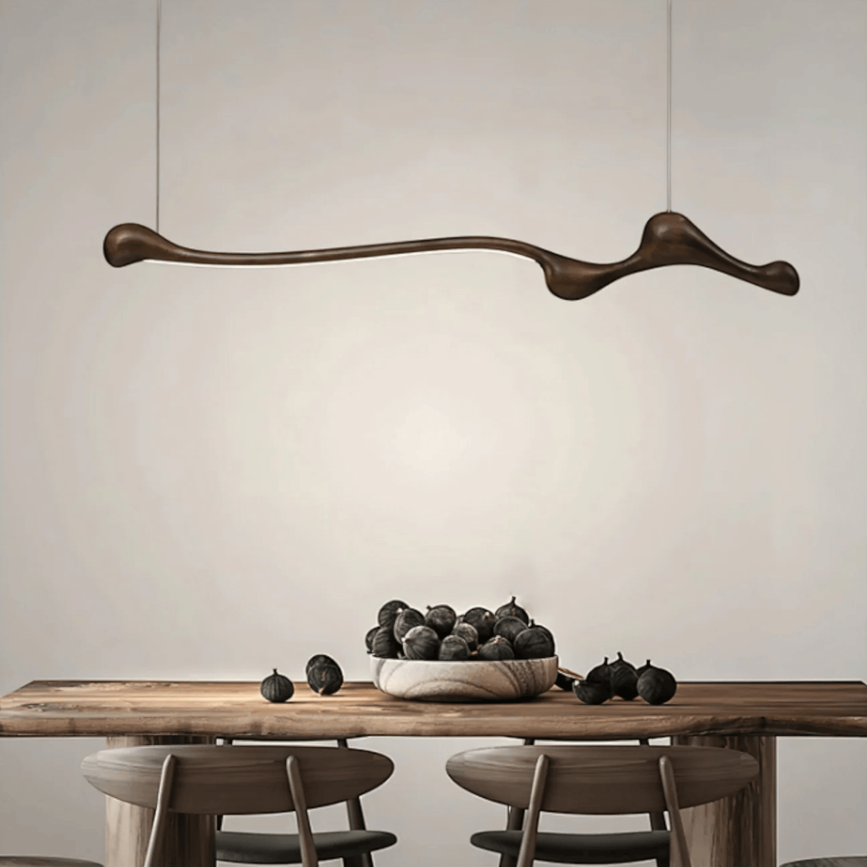Modern dining room with a wooden table, chairs, and a decorative pendant light.