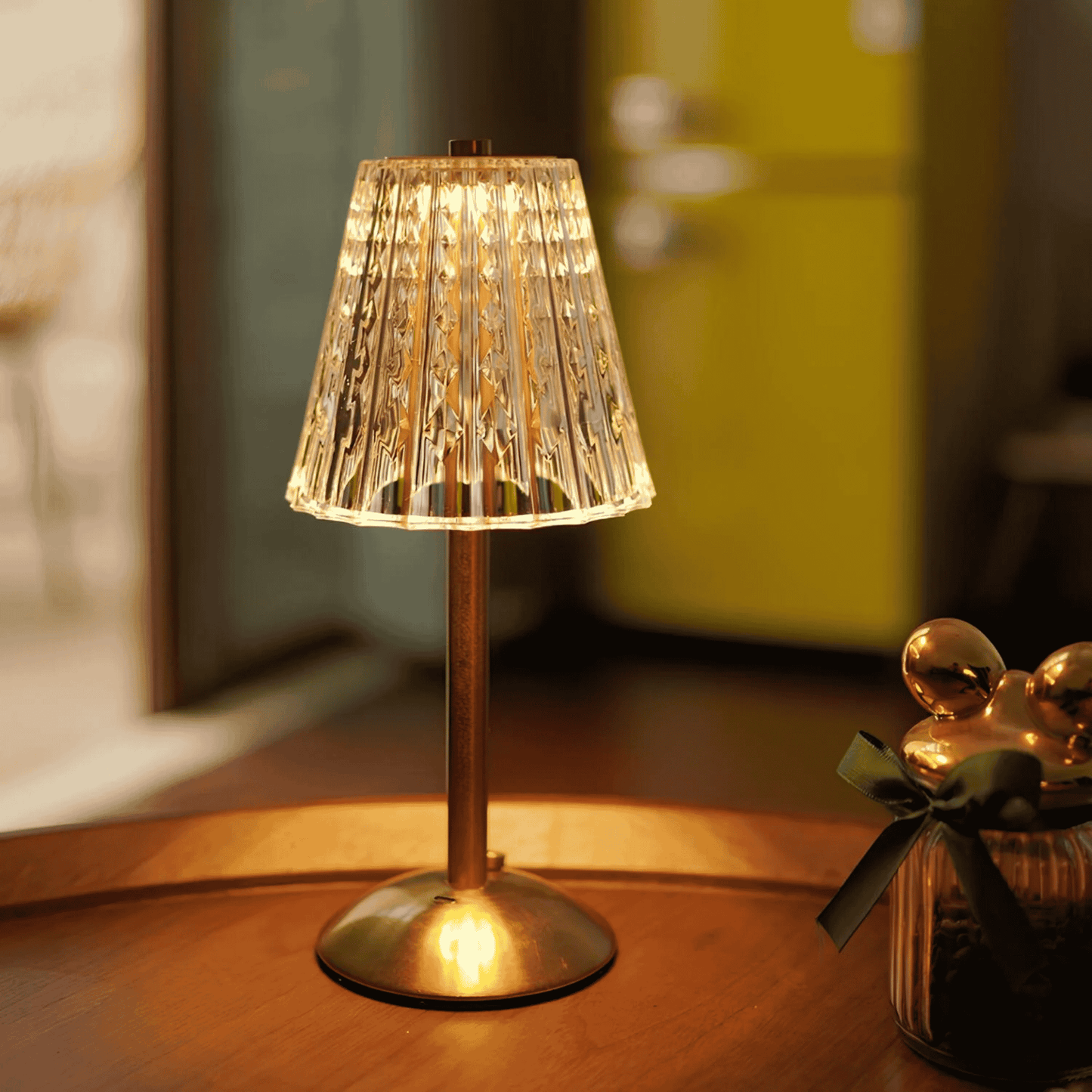 Decorative table lamp with pleated shade on a wooden surface