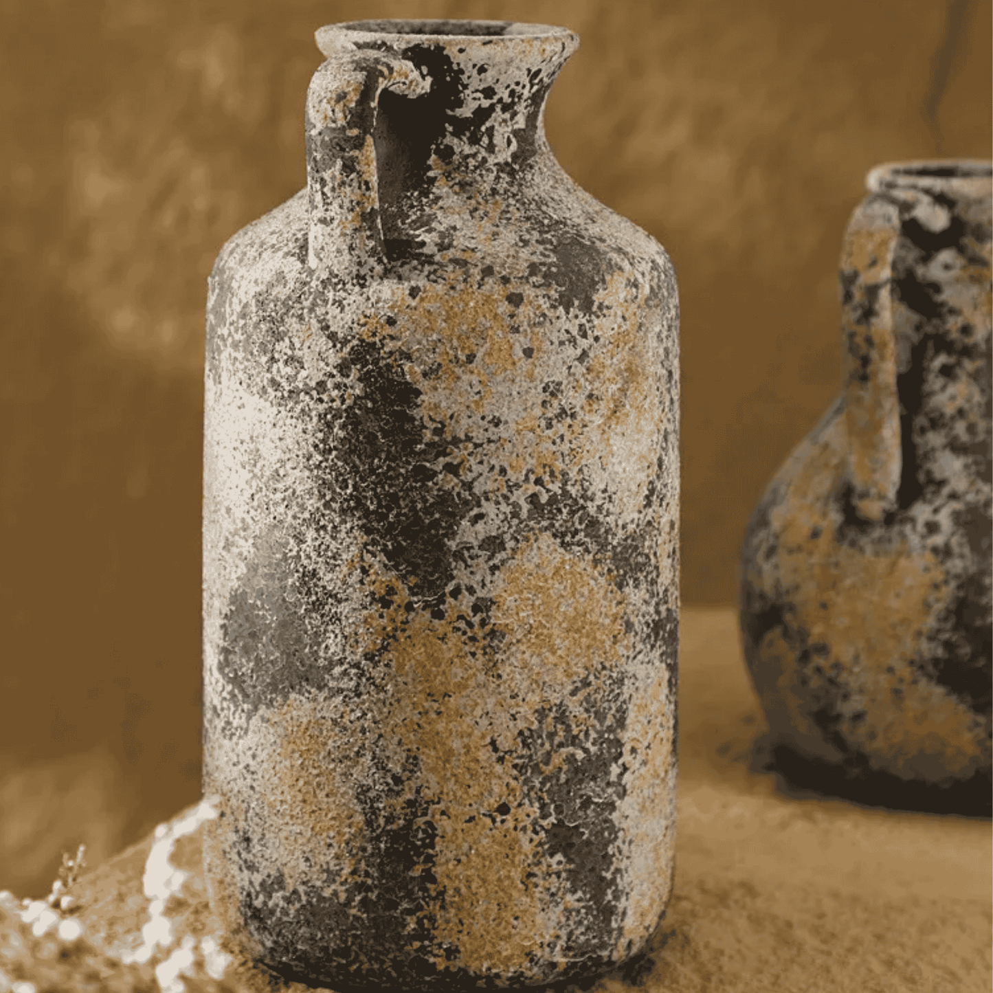 Two rustic ceramic vases with a textured surface on a beige background