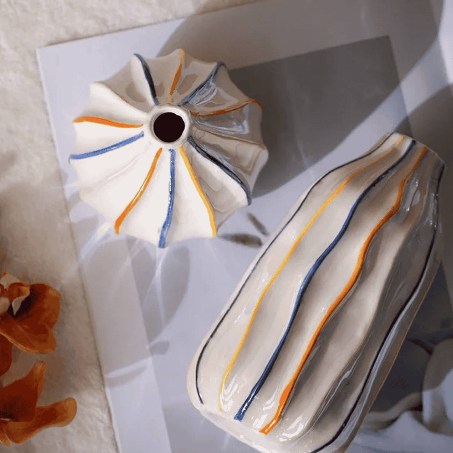 Decorative ceramic plate with colorful stripes on a white surface