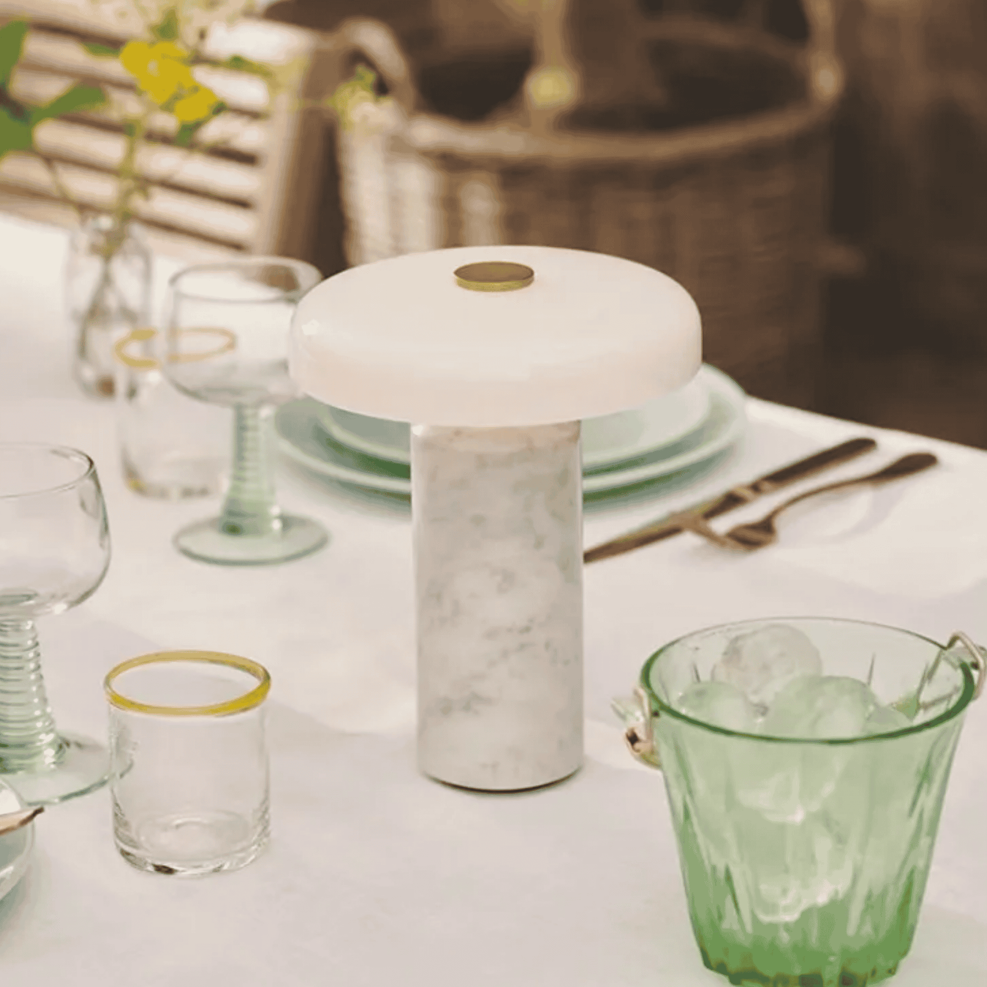 Decorative lamp on a table with glasses and cutlery