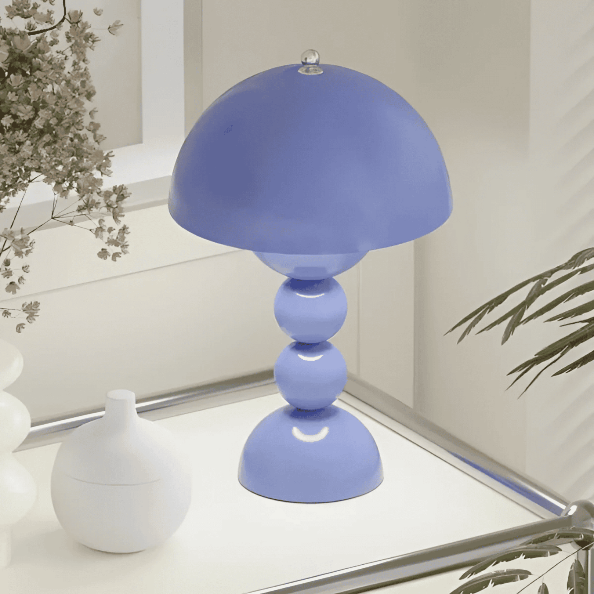Blue table lamp on a surface with decorative elements in the background