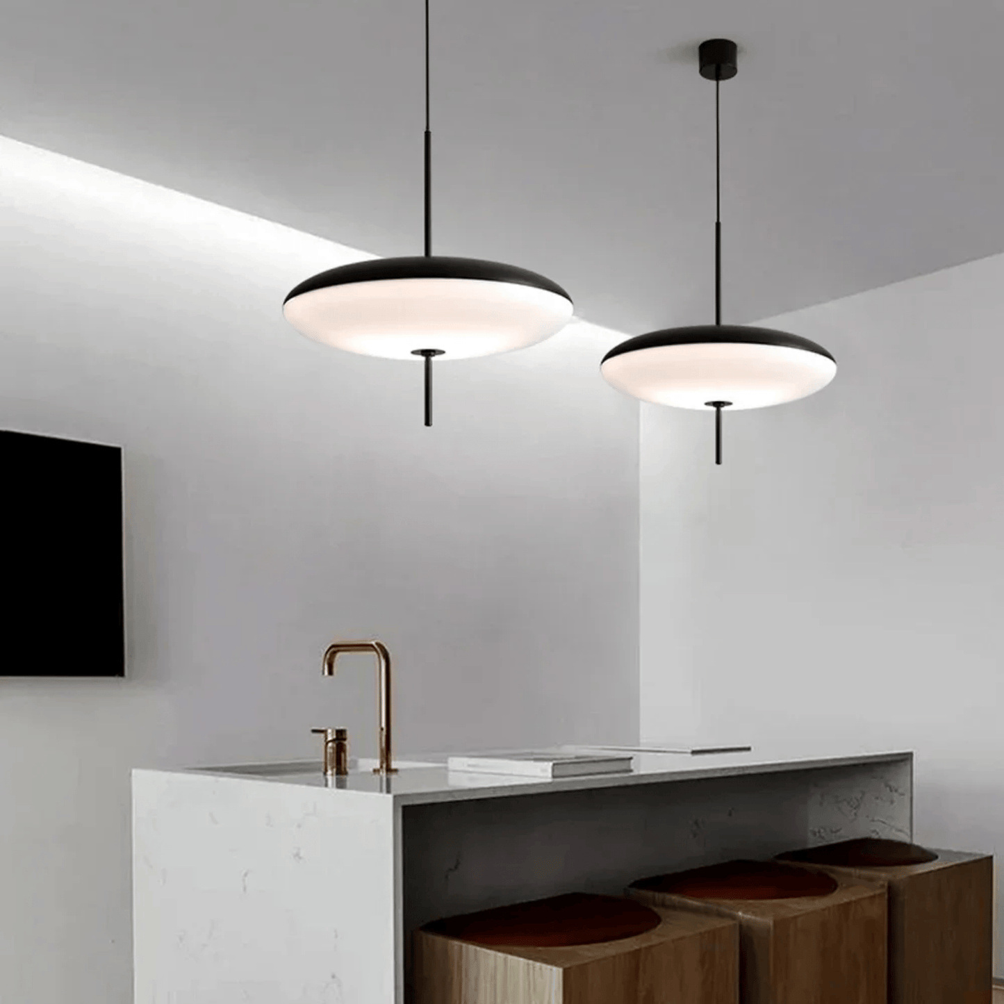 Modern kitchen with pendant lights and a white island.