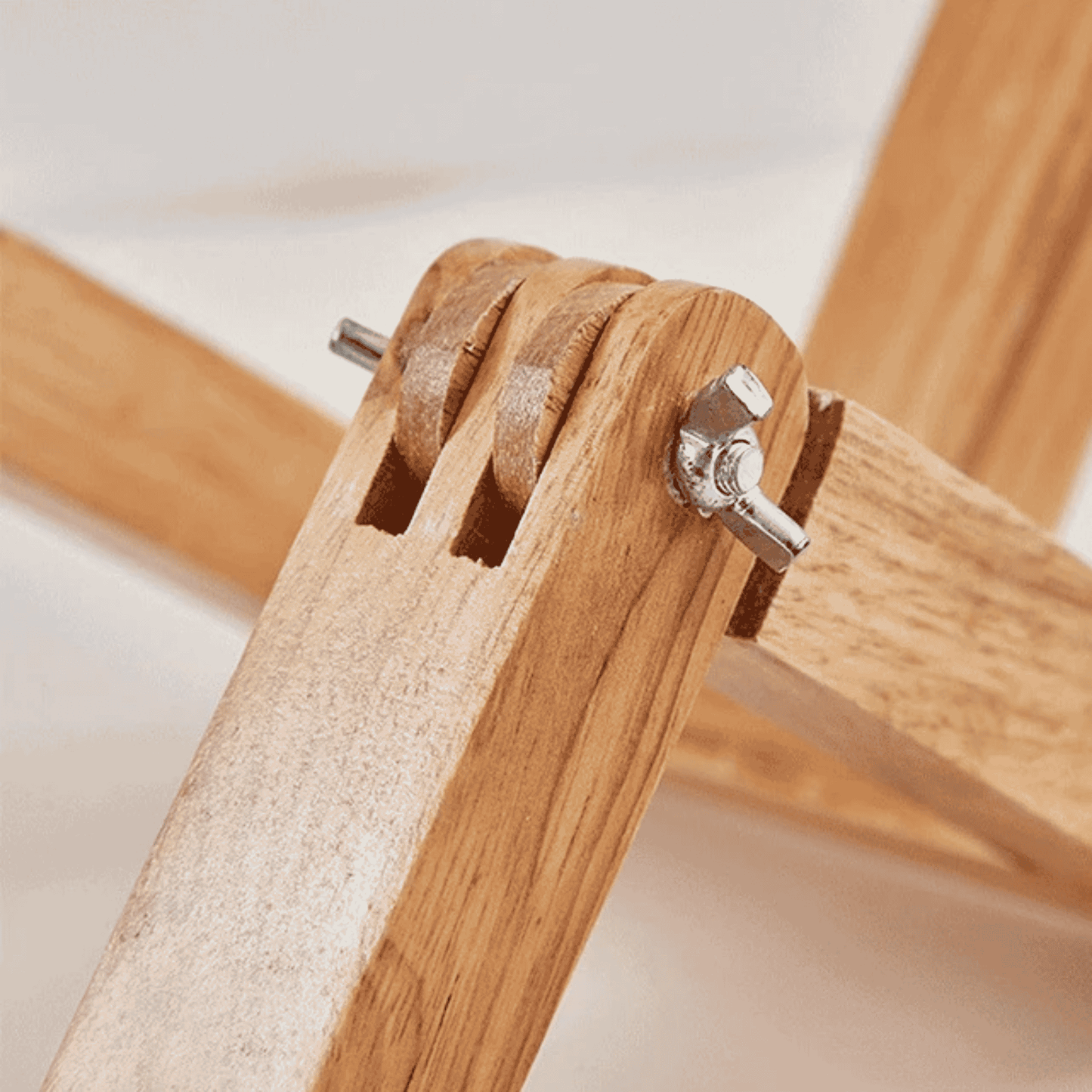 Close-up of wooden furniture with metal brackets on a light background