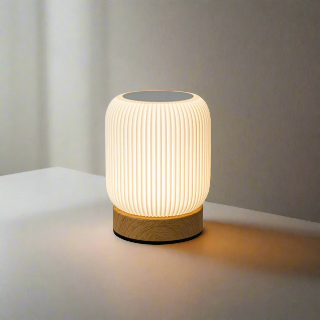 Table lamp with ribbed design and wooden base on a white background