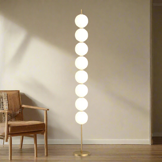 Modern floor lamp with round glass shades on a beige background