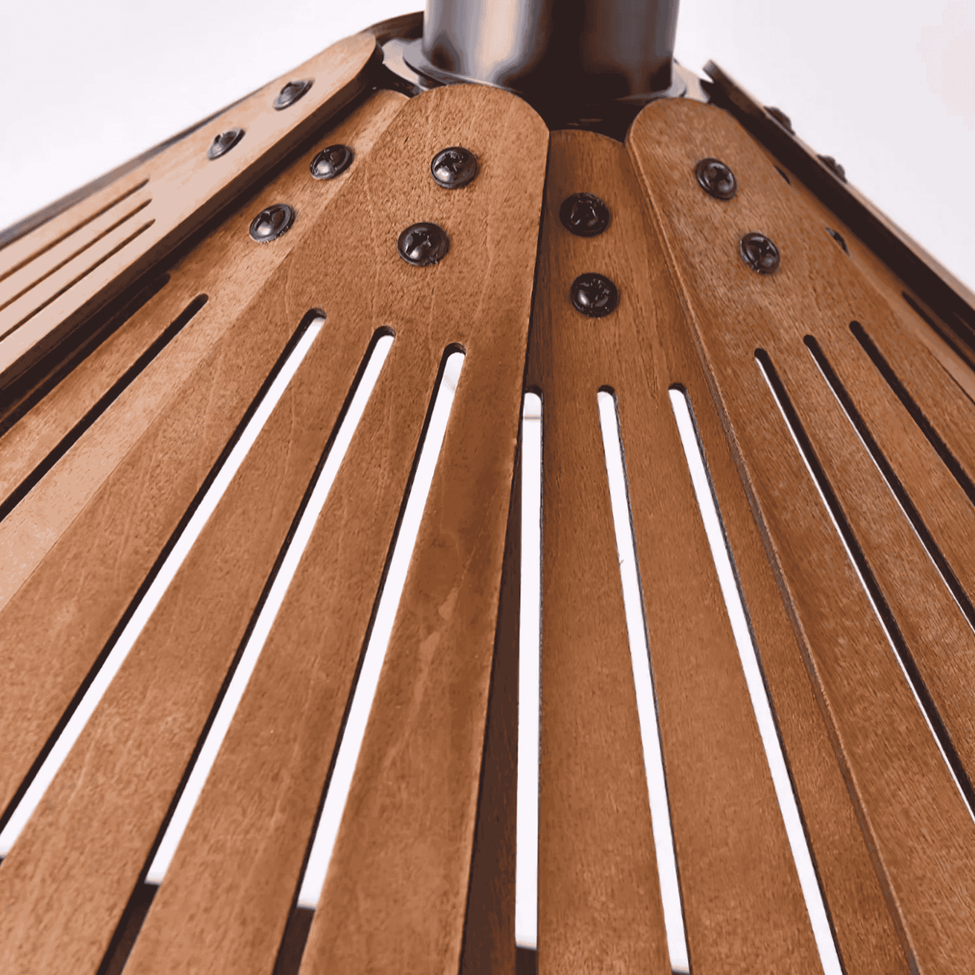 Close-up of a wooden ceiling light with slatted design and metal legs.