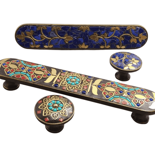 Decorative cabinet handles with intricate designs on a white background