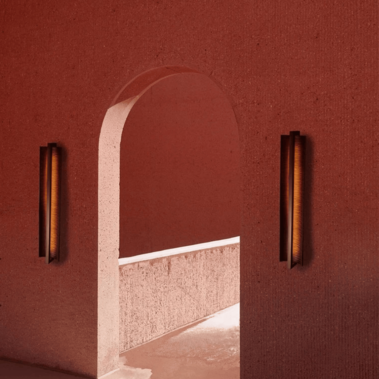 Archway framed by two wall lights against a red wall