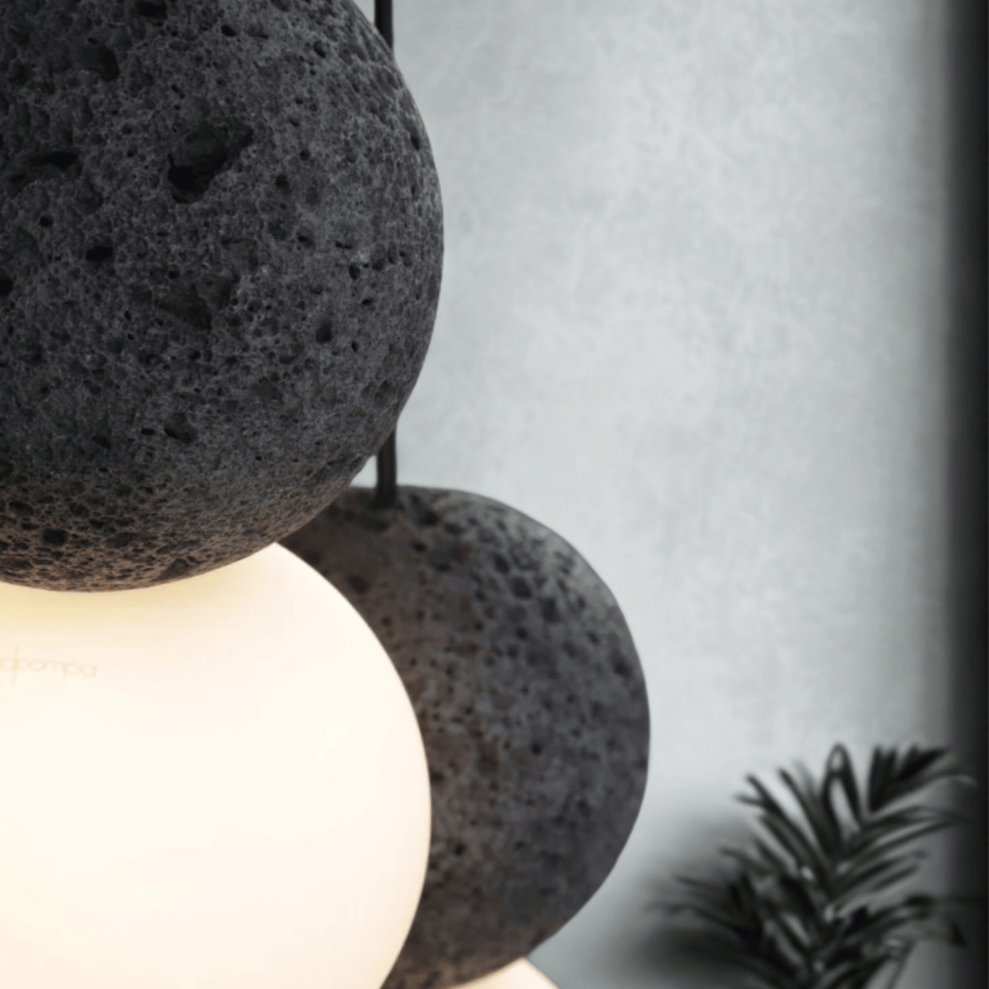 Decorative lamp with textured black shade and white base against a neutral background