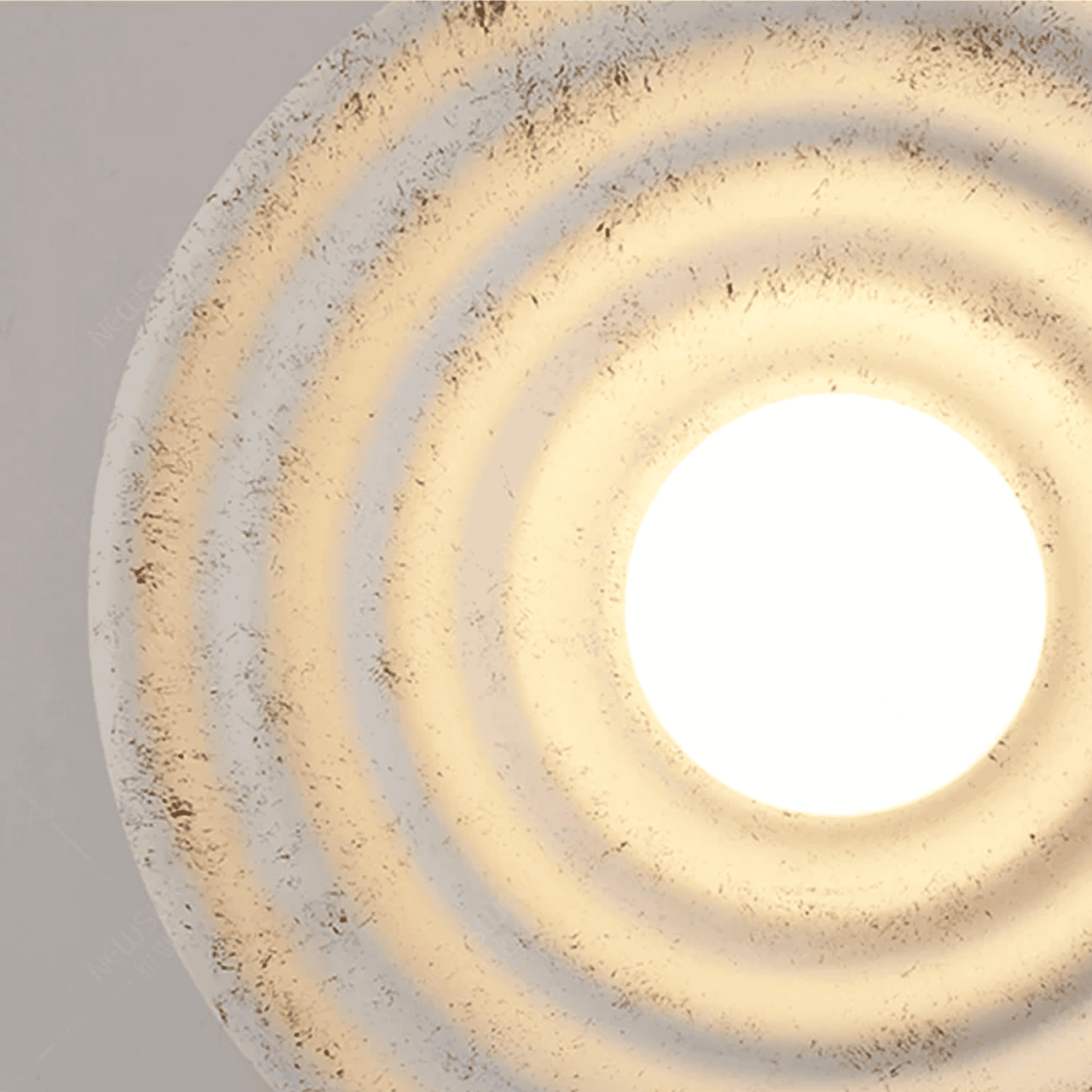 Close-up of a decorative ceiling light fixture with concentric circular design.