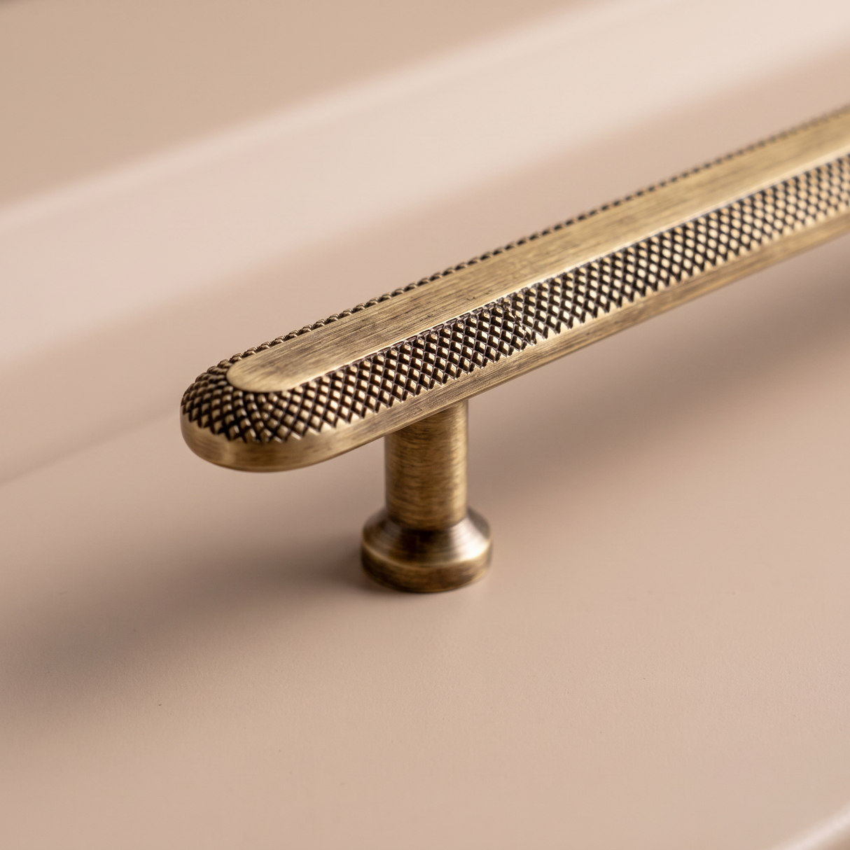 Close-up of Veyra solid brass round cabinet knob with fine knurled antique bronze finish