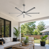 Ceiling fan in a modern outdoor living space with furniture and plants.