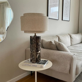 Living room with a lamp on a side table next to a sofa