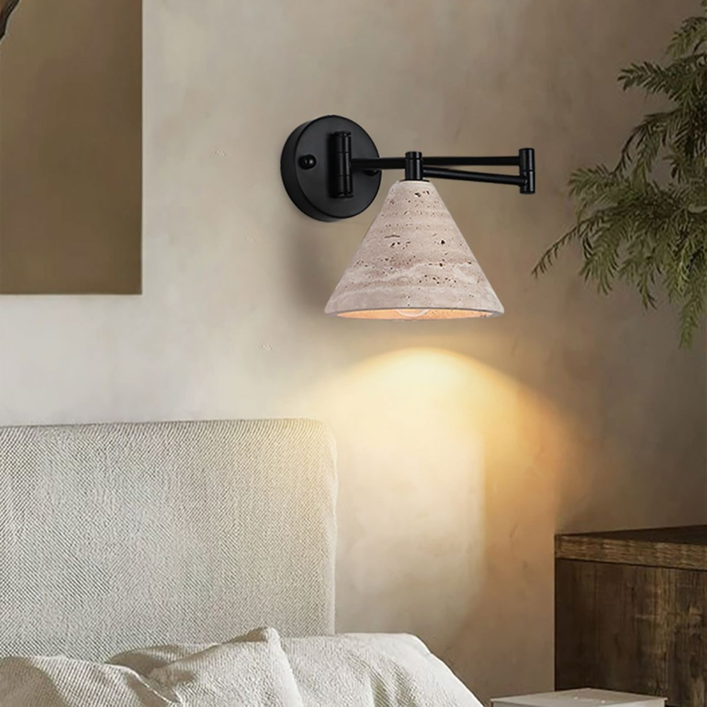 Wall-mounted light fixture with concrete shade in a bedroom setting