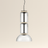 Modern pendant light with three cylindrical glass shades on a beige background