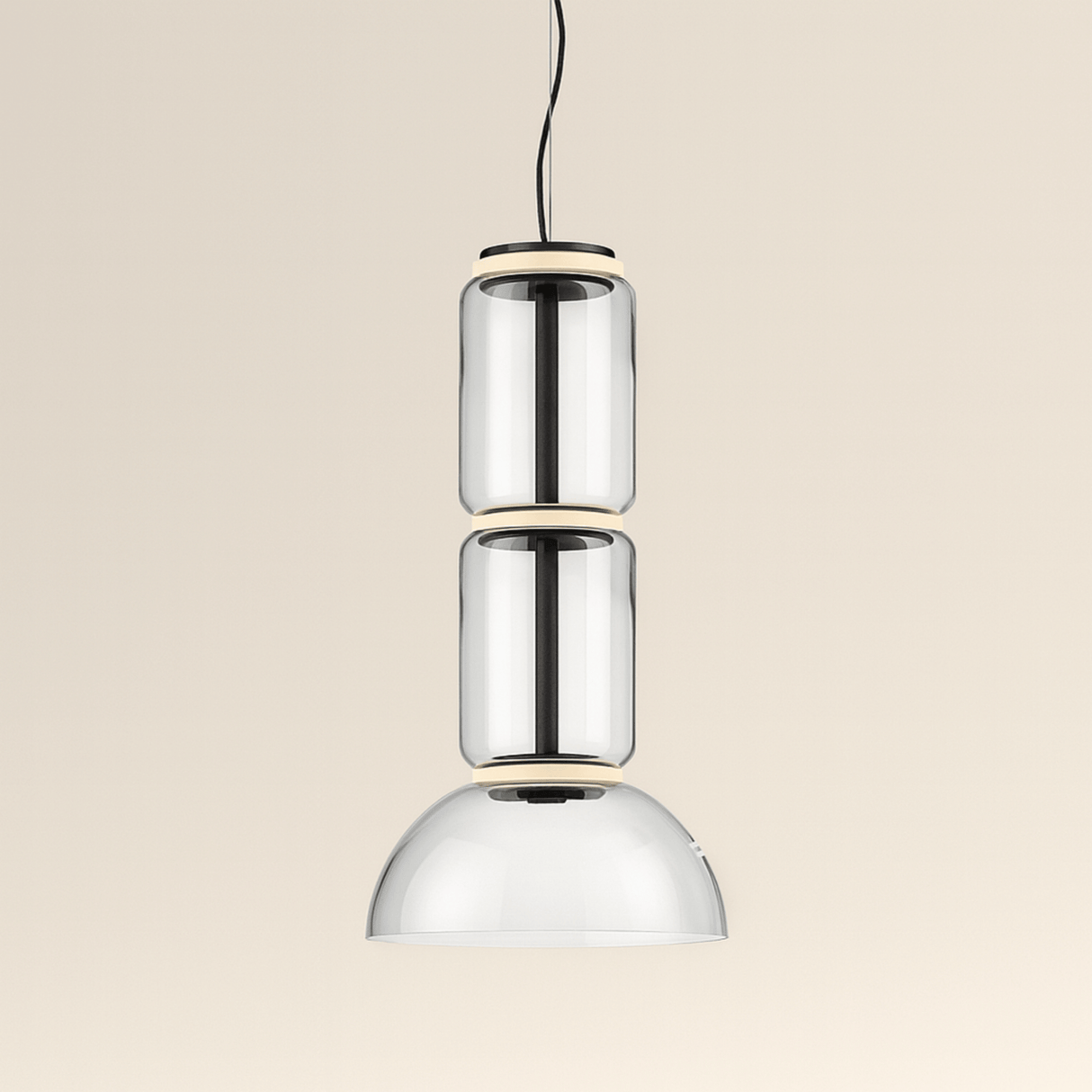 Modern pendant light with three cylindrical glass shades on a beige background
