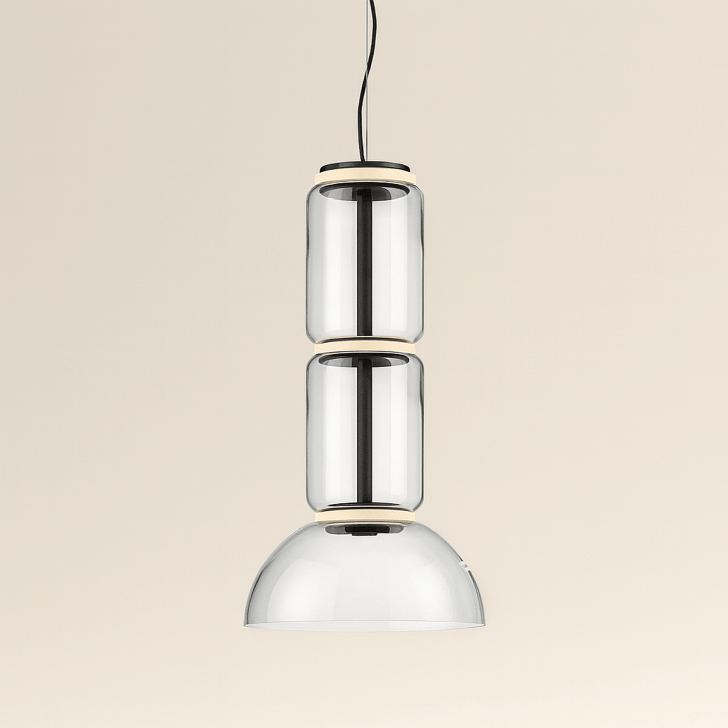 Modern pendant light with three cylindrical glass shades on a beige background
