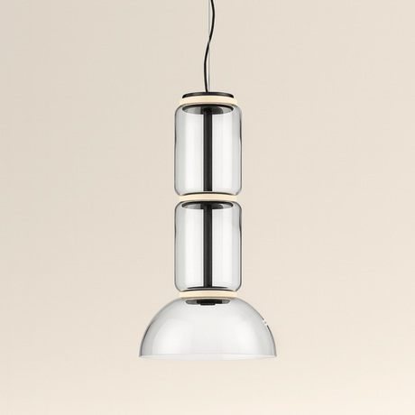 Modern pendant light with three cylindrical glass shades on a beige background