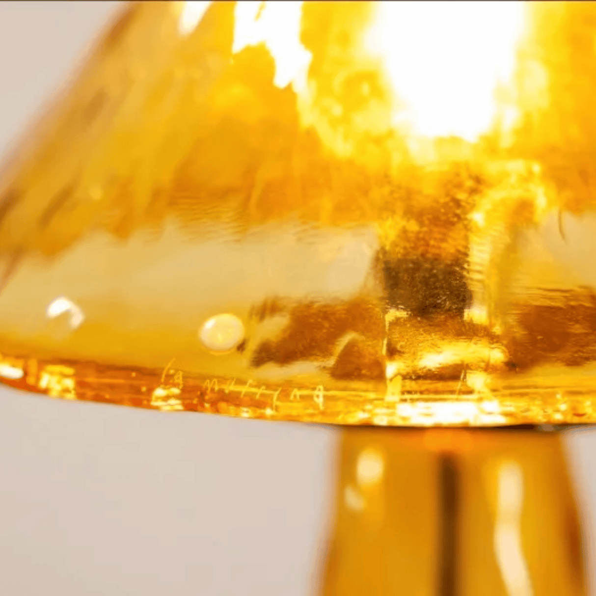 Close-up of a yellow glass object with a blurred background