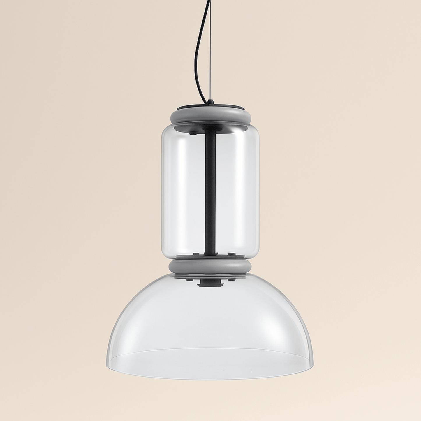 Modern pendant light with two cylindrical glass shades on a beige background