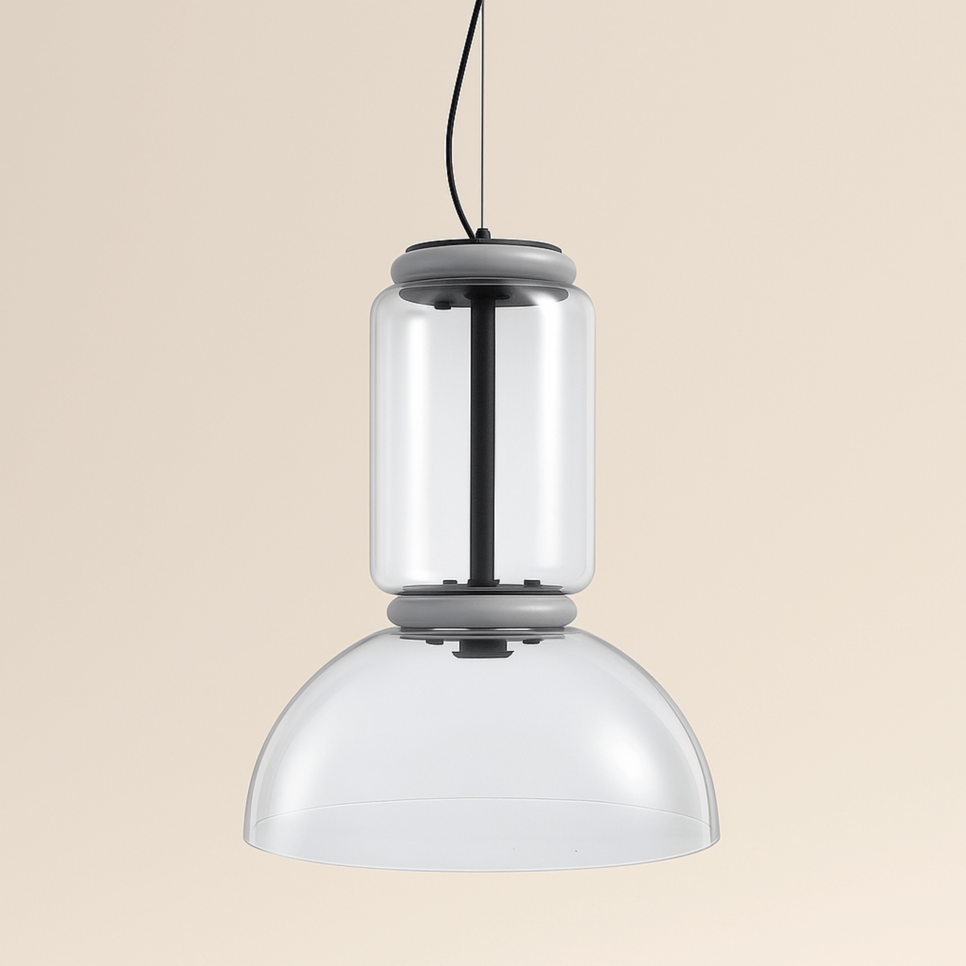 Modern pendant light with two cylindrical glass shades on a beige background