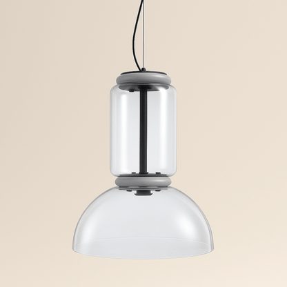 Modern pendant light with two cylindrical glass shades on a beige background
