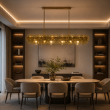 Dining room with a modern chandelier, table, and chairs.