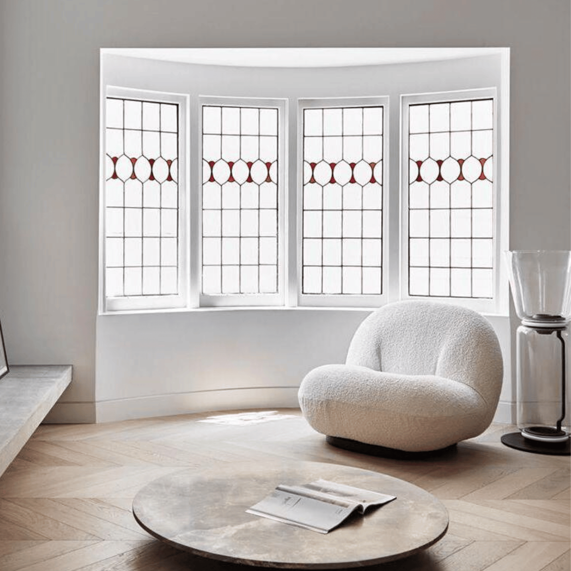 Modern living room with a textured white armchair and round wooden coffee table.
