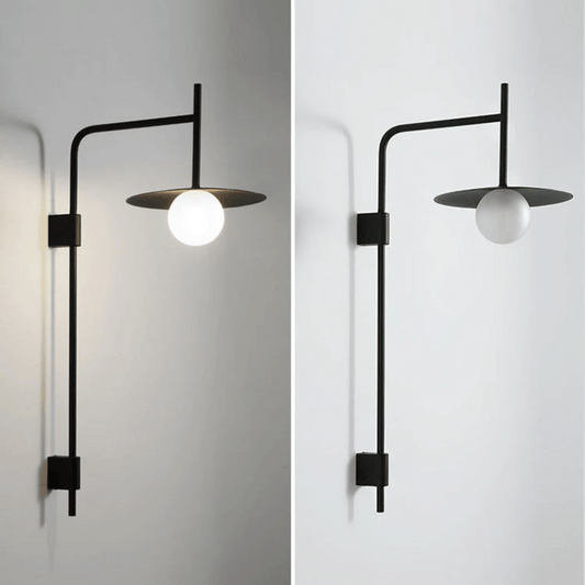 Modern wall-mounted light fixture with a black frame and white bulb on a plain background.