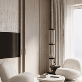 Modern living room with neutral tones, white chairs, and a TV mounted on the wall.