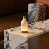 Decorative bottle lamp on a marble surface with a blurred background