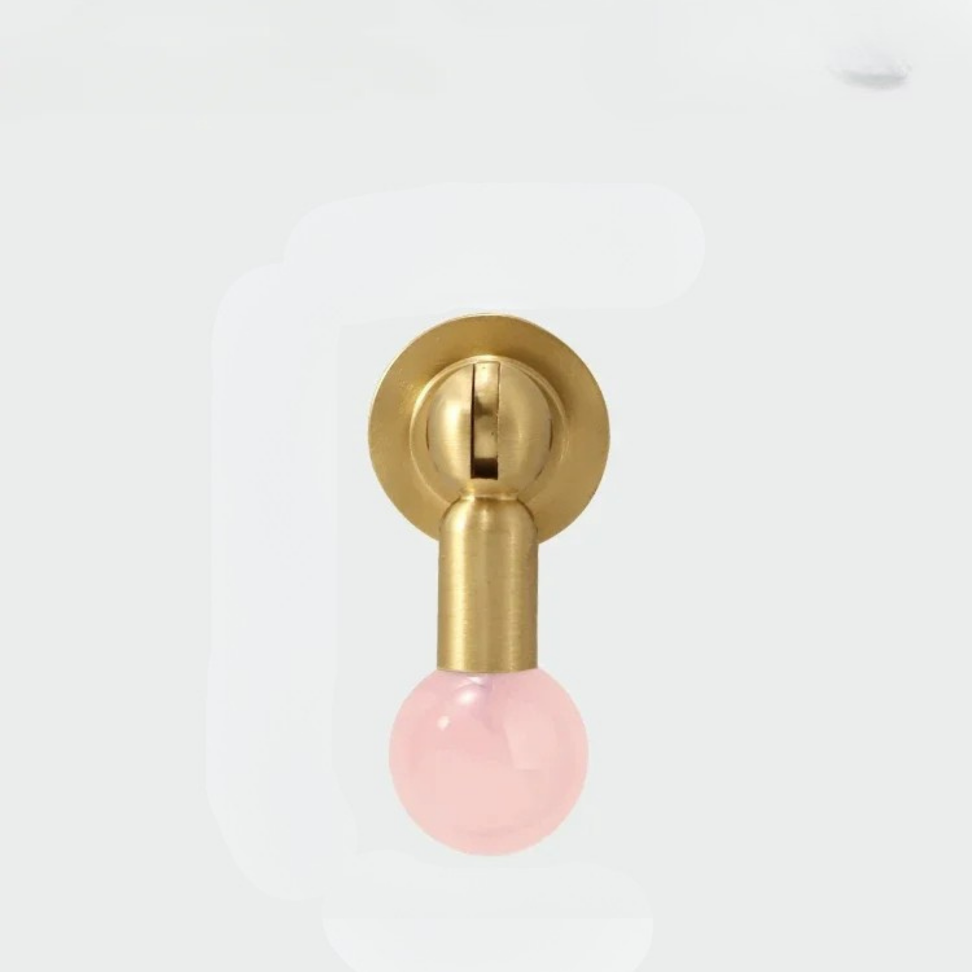 Brass knob with glossy pink gemstone sphere handle photographed on a white background.